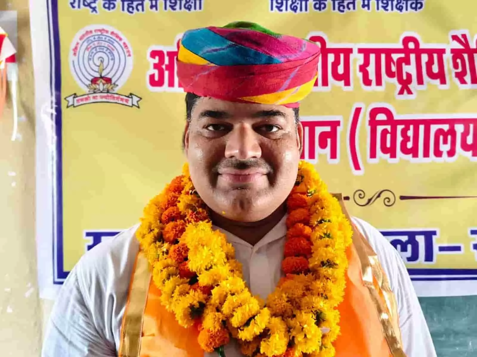 तस्वीर में राष्ट्रीय शैक्षिक महासंघ के नवनियुक्त अध्यक्ष मुकेश वैष्णव साफा और माला पहने खड़े हैं। तस्वीर में राष्ट्रीय शैक्षिक महासंघ के नवनियुक्त अध्यक्ष मुकेश वैष्णव साफा और माला पहने खड़े हैं।