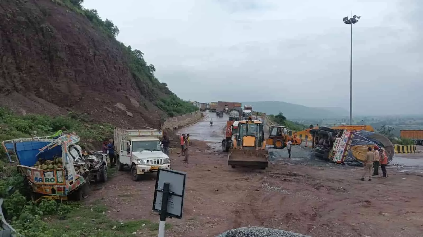 पहाड़ी सड़क किनारे खड़ा क्षतिग्रस्त पिकप वाहन और जेसीबी के पास पलटा ट्रक दिखाई दे रहा है। पहाड़ी सड़क किनारे खड़ा क्षतिग्रस्त पिकप वाहन और जेसीबी के पास पलटा ट्रक दिखाई दे रहा है।