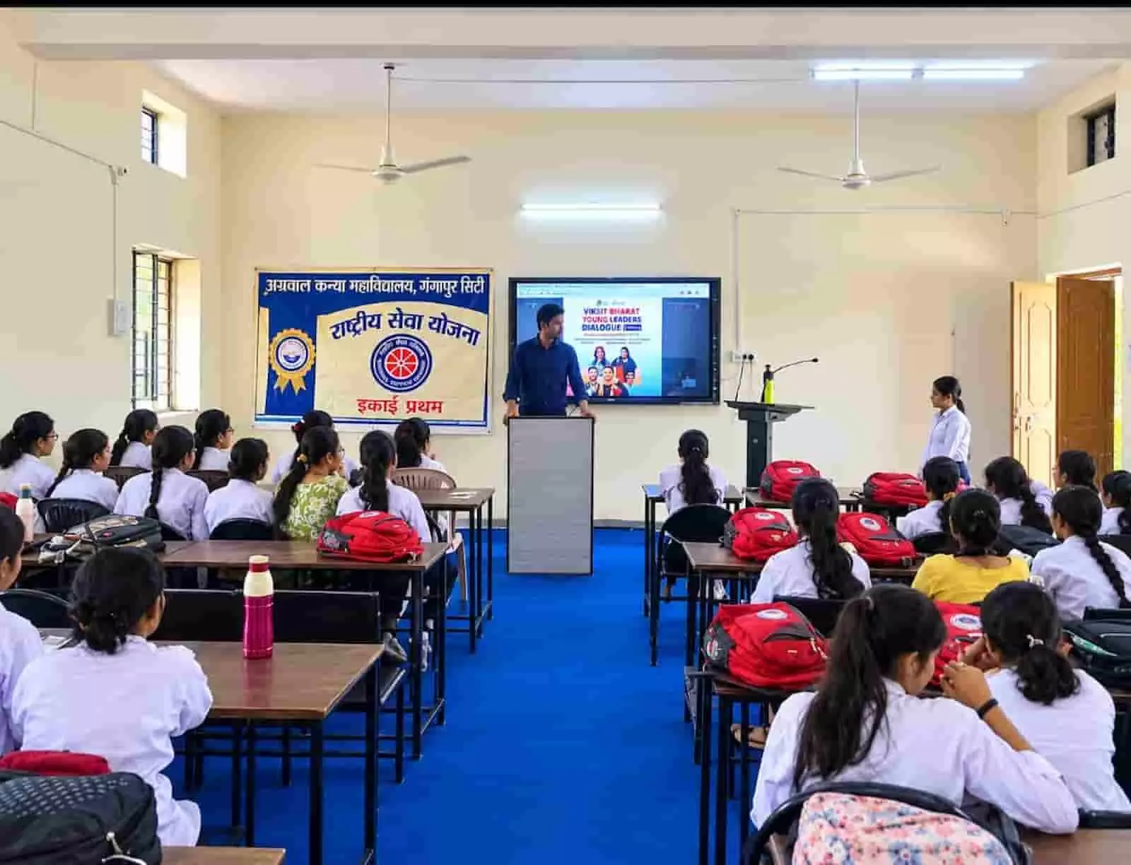 तस्वीर में दिख रही छात्राओं को हॉल में एक प्रवक्ता संबोधित कर रहे हैं। तस्वीर में दिख रही छात्राओं को हॉल में एक प्रवक्ता संबोधित कर रहे हैं।