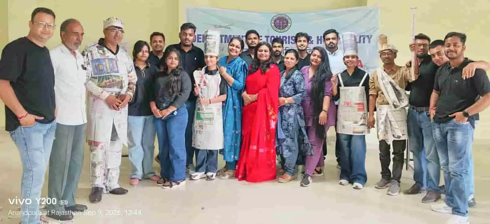 कोटा विश्वविद्यालय के पर्यटन विभाग में पुराने अखबारों से पोशाकें बनाने वाले विद्यार्थी और संकाय सदस्य। कोटा विश्वविद्यालय के पर्यटन विभाग में पुराने अखबारों से पोशाकें बनाने वाले विद्यार्थी और संकाय सदस्य।