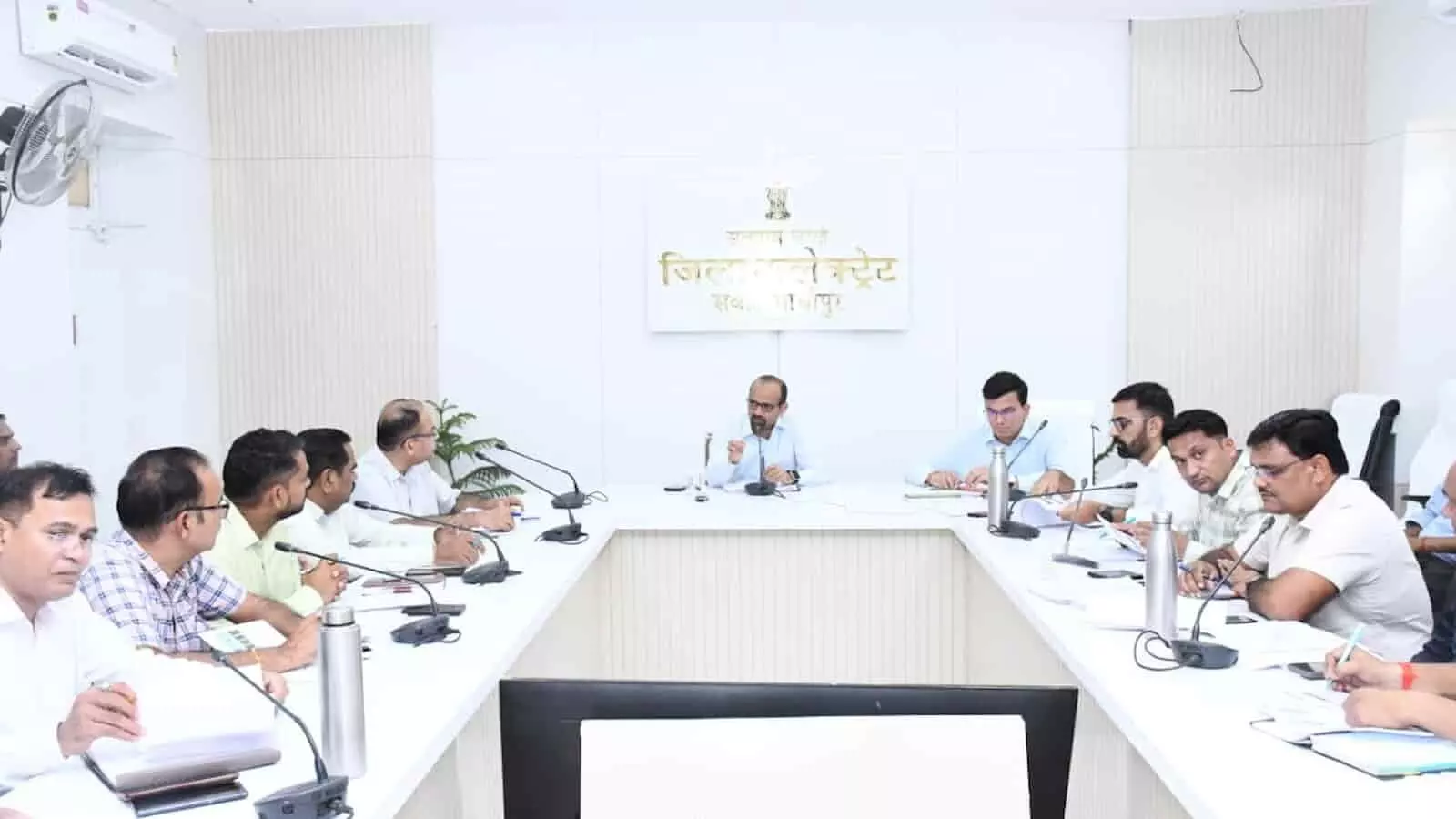 तस्वीर में जिला कलक्टर काना राम अन्य प्रशासनिक अधिकारियों के साथ बैठक में चर्चा करते हुए visible हैं। तस्वीर में जिला कलक्टर काना राम अन्य प्रशासनिक अधिकारियों के साथ बैठक में चर्चा करते हुए visible हैं।