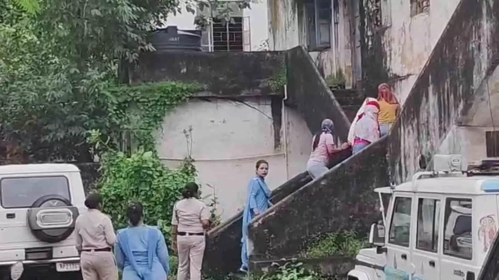 तस्वीर में बाएं से दाएं नीचे खड़ी पुलिसकर्मी और सीढ़ियों पर चढ़ती हुई महिलाएं दिखाई दे रही हैं। तस्वीर में बाएं से दाएं नीचे खड़ी पुलिसकर्मी और सीढ़ियों पर चढ़ती हुई महिलाएं दिखाई दे रही हैं।