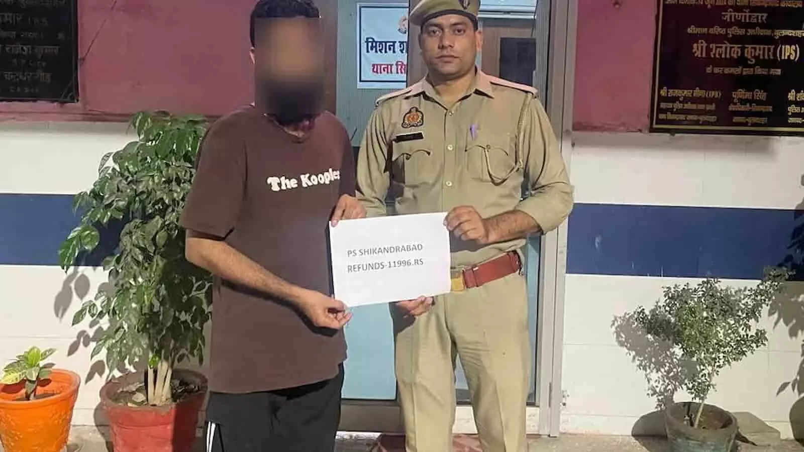 तस्वीर में एक पुलिसकर्मी और एक व्यक्ति थाने के बाहर खड़े होकर रिफंड से संबंधित कागज पकड़े हुए हैं। तस्वीर में एक पुलिसकर्मी और एक व्यक्ति थाने के बाहर खड़े होकर रिफंड से संबंधित कागज पकड़े हुए हैं।