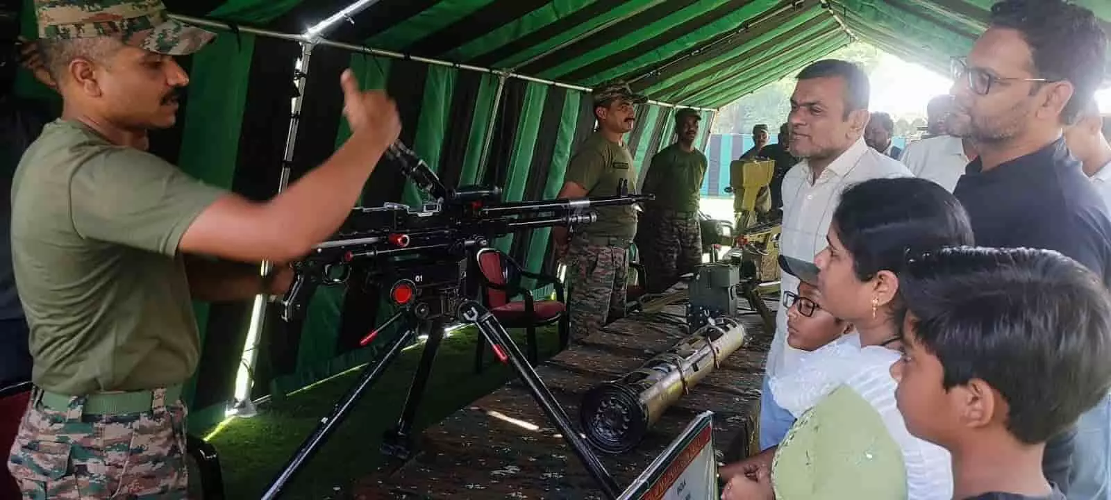 तस्वीर में बाईं ओर खड़े भारतीय सेना के जवान टेंट में मौजूद लोगों को हथियार की विशेषताएं बता रहे हैं। तस्वीर में बाईं ओर खड़े भारतीय सेना के जवान टेंट में मौजूद लोगों को हथियार की विशेषताएं बता रहे हैं।