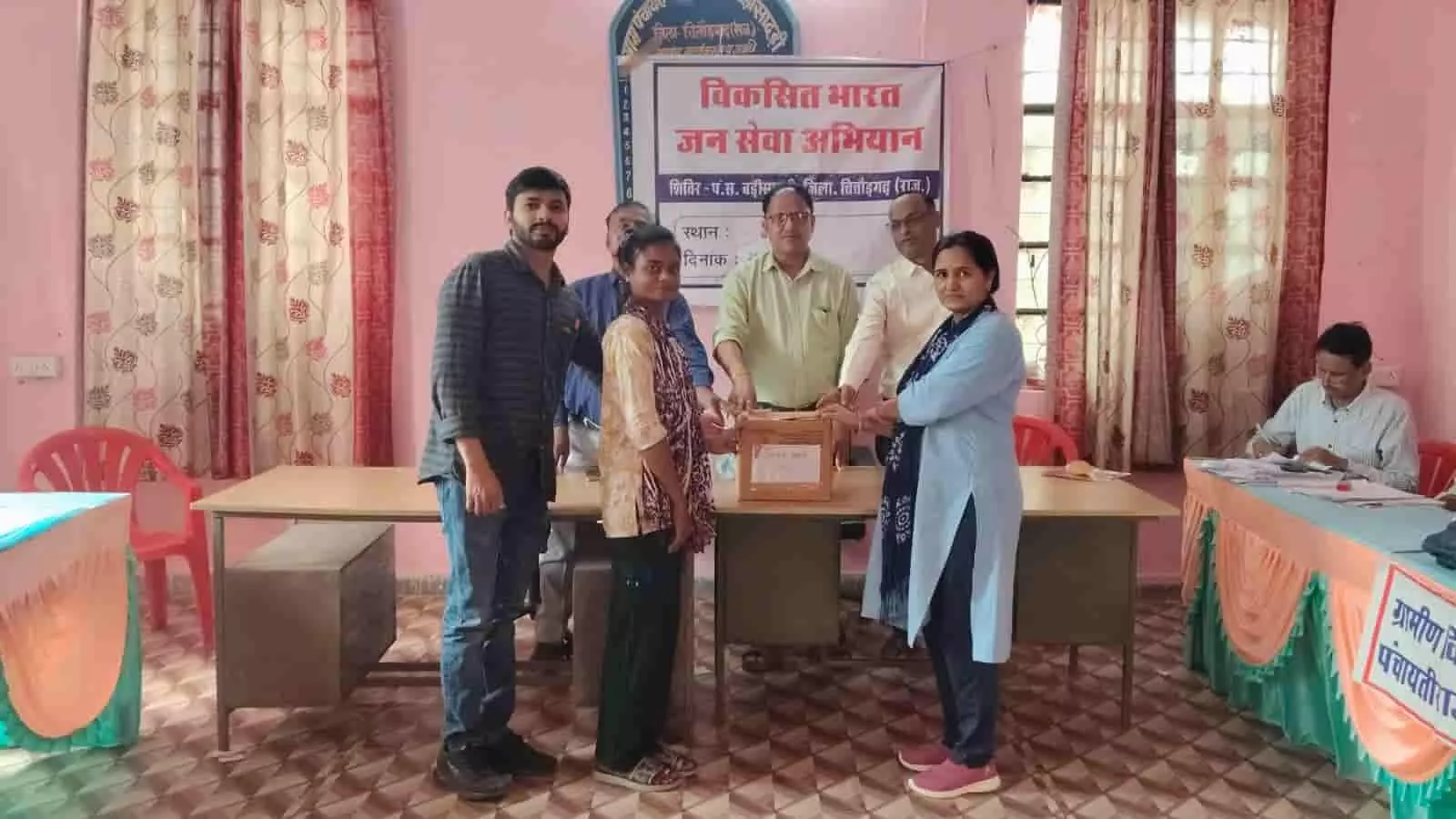 बड़ी सादड़ी के विकसित भारत जन सेवा शिविर में अधिकारी और कर्मचारी एक महिला को बॉक्स सौंपते हुए। बड़ी सादड़ी के विकसित भारत जन सेवा शिविर में अधिकारी और कर्मचारी एक महिला को बॉक्स सौंपते हुए।