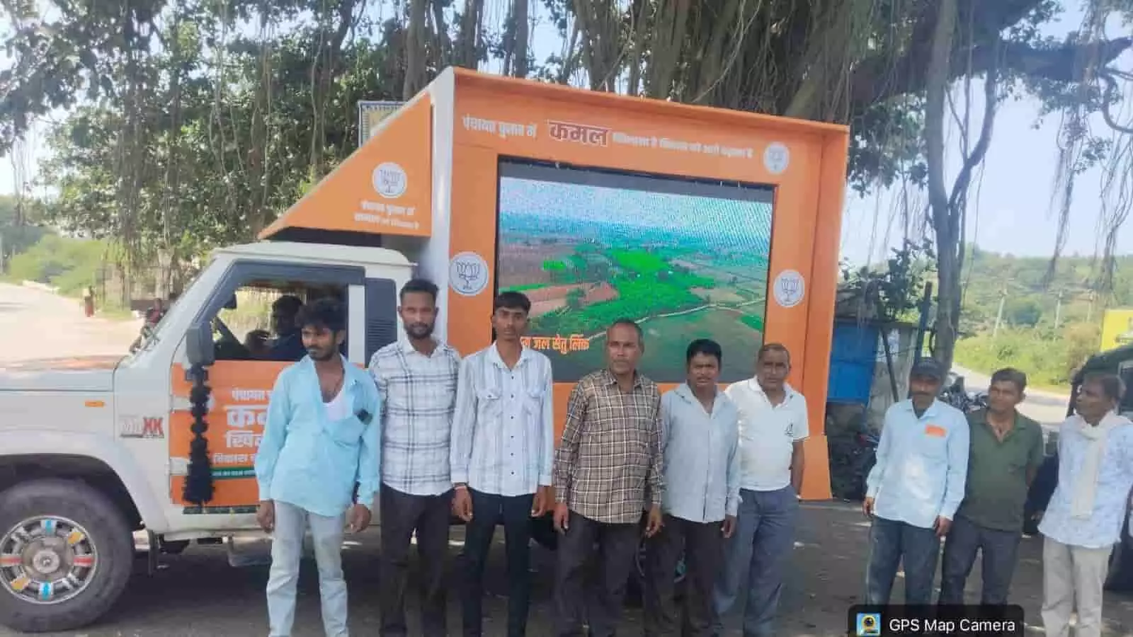 तस्वीर में दिख रही प्रचार गाड़ी और एलईडी स्क्रीन के आगे कई लोग कतार में खड़े हैं। तस्वीर में दिख रही प्रचार गाड़ी और एलईडी स्क्रीन के आगे कई लोग कतार में खड़े हैं।