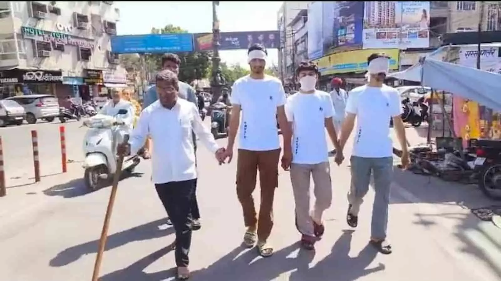 तस्वीर में बाएं से दाएं हाथ में लाठी लिए मनोज पालीवाल और तीन अन्य लोग सड़क पर चलते दिख रहे हैं। तस्वीर में बाएं से दाएं हाथ में लाठी लिए मनोज पालीवाल और तीन अन्य लोग सड़क पर चलते दिख रहे हैं।