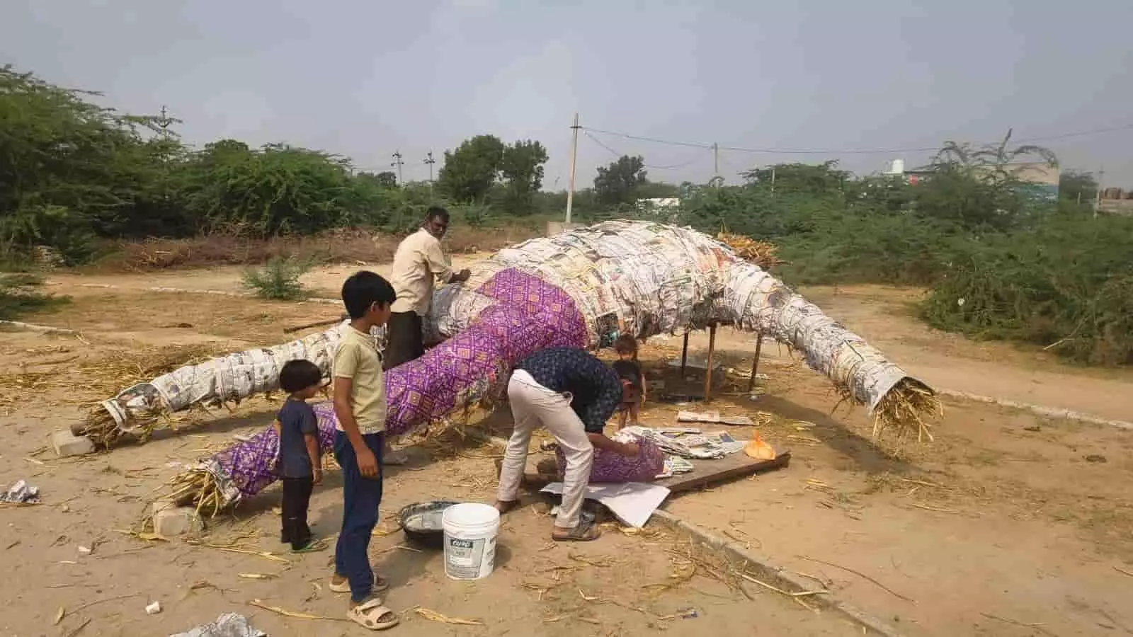 तस्वीर में मैदान में विजयादशमी पर दहन के लिए रावण का पुतला बनाते हुए लोग दिख रहे हैं। तस्वीर में मैदान में विजयादशमी पर दहन के लिए रावण का पुतला बनाते हुए लोग दिख रहे हैं।