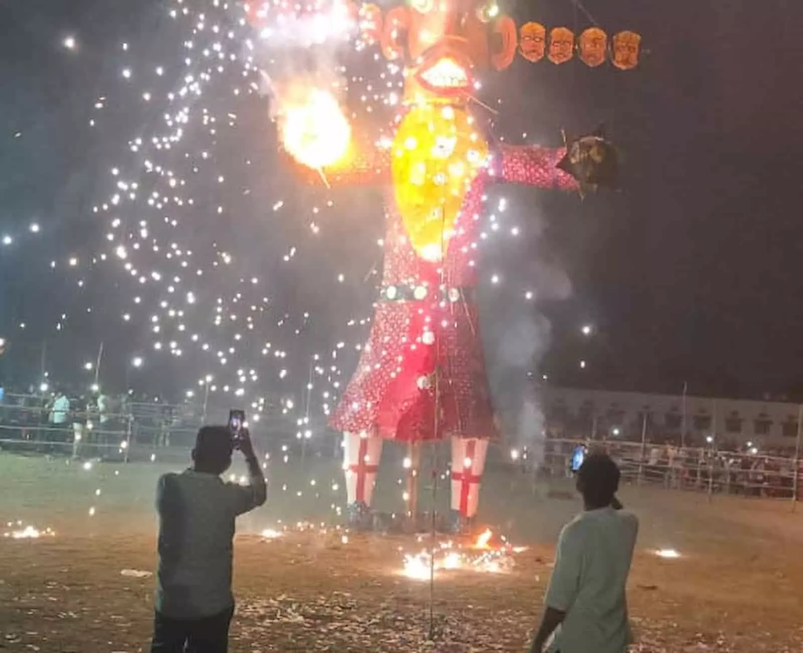 तस्वीर में खेल मैदान में जलता हुआ रावण का पुतला और आतिशबाजी दिख रही है। तस्वीर में खेल मैदान में जलता हुआ रावण का पुतला और आतिशबाजी दिख रही है।
