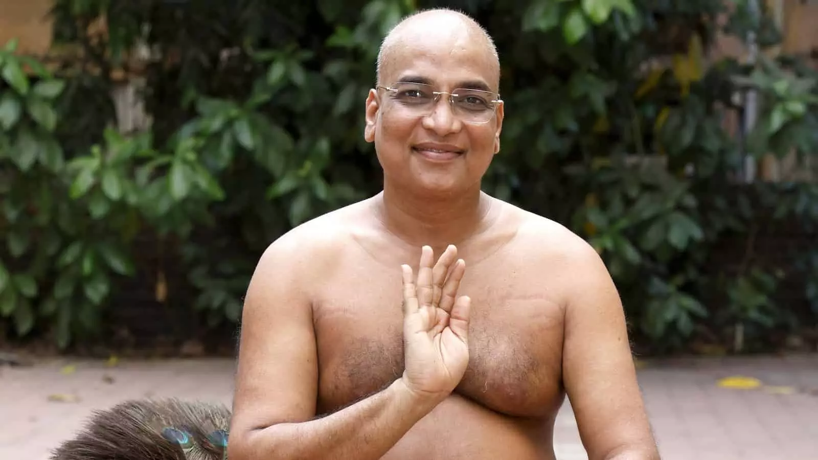 तस्वीर में लकड़ी की चौकी पर आशीर्वाद मुद्रा में बैठे जैन मुनि और पास में रखी पिच्छिका। तस्वीर में लकड़ी की चौकी पर आशीर्वाद मुद्रा में बैठे जैन मुनि और पास में रखी पिच्छिका।